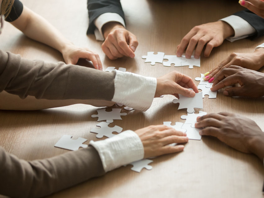 Business Executives putting puzzle pieces together