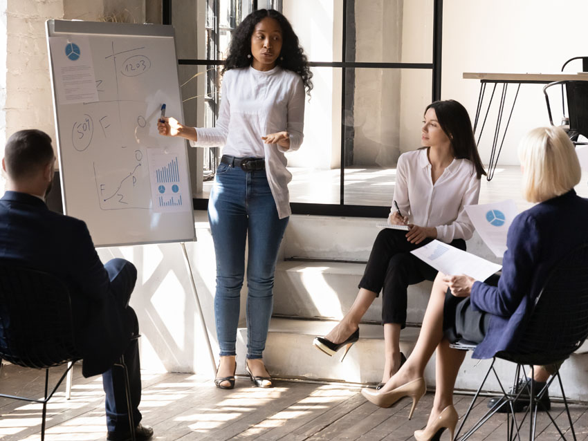 A group of executives in a meeting comparing health benefit costs.