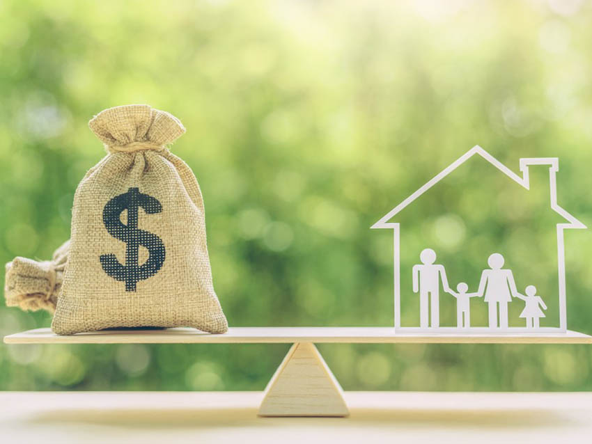 Picture of a scale with money on one side and a household family on the other