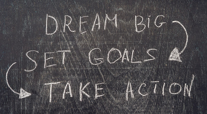 Photo of a chalkboard with: Dream Big, Set Goals, Take Action.