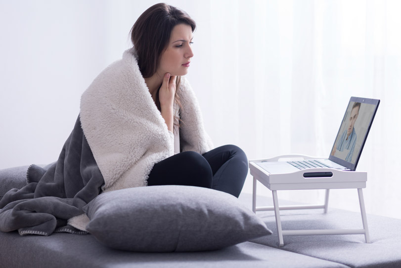 Photo of Woman using TeleHealth Services on laptop